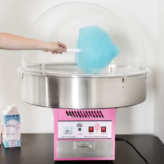 Blue cotton candy being spun in a cotton candy machine