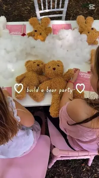 Children at a teddy bear stuffing table with plush bears and stuffing